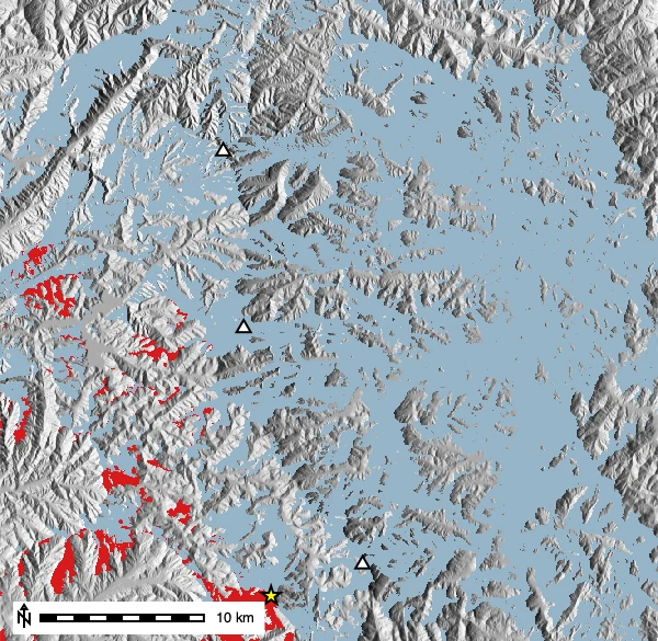 Existing coverage (blue), the candidate fourth tower (star), and the small area it recovers (red). Most gaps are valleys no ridgetop tower can see.